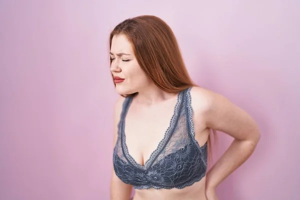 Redhead Woman Wearing Lingerie Pink Background Suffering Backache Touching Back — Stock Photo, Image