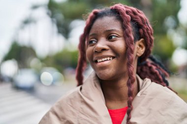 African american woman smiling confident looking to the side at street