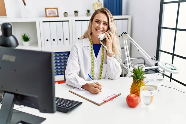 Young Woman Dietician Talking Telephone Writing Document Clinic — Stock Photo, Image