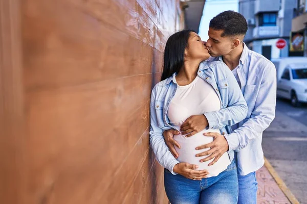 Young Latin Couple Expecting Baby Touching Belly Kissing Street — Stok fotoğraf