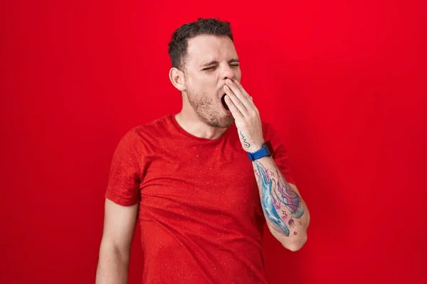 Young Hispanic Man Standing Red Background Bored Yawning Tired Covering — Stockfoto