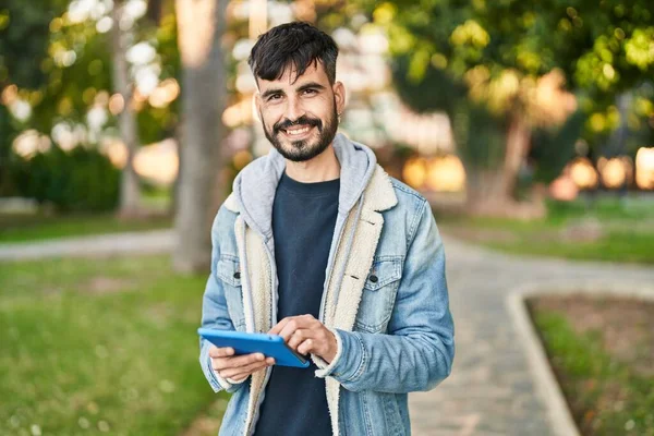 Young Hispanic Man Smiling Confident Using Touchpad Park —  Fotos de Stock