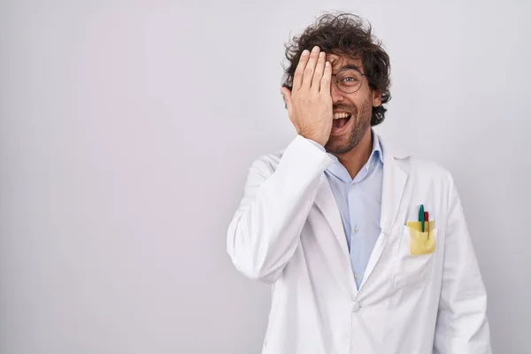 Hispanic Young Man Wearing Doctor Uniform Covering One Eye Hand — Stock Photo, Image