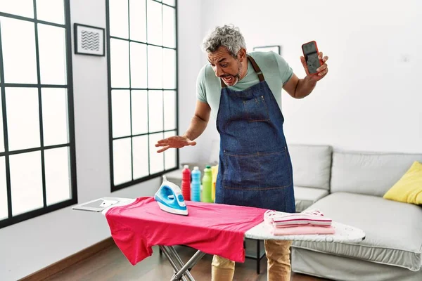 Middle Age Grey Haired Man Holding Smartphone Burning Shirt Iron — Photo