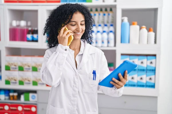 Young Hispanic Woman Pharmacist Talking Smartphone Using Touchpad Pharmacy — Stockfoto