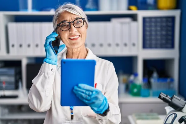 Middle Age Grey Haired Woman Scientist Using Touchpad Talking Smartphone —  Fotos de Stock