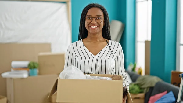 African American Woman Smiling Confident Holding Package New Home — Foto de Stock