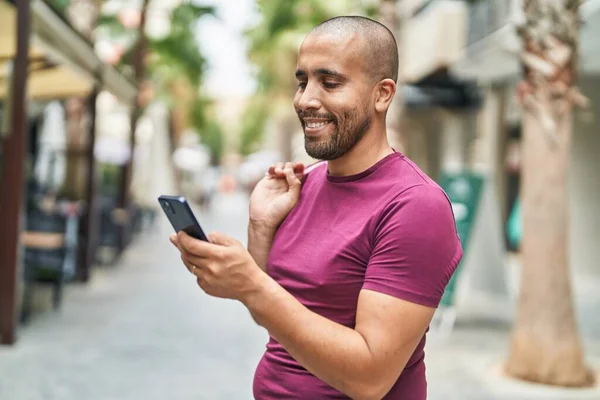 Young Latin Man Using Smartphone Holding Shopping Bag Street — 图库照片
