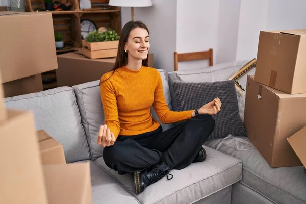 Young Caucasian Woman Doing Yoga Exercise Sitting Sofa New Home — Fotografia de Stock