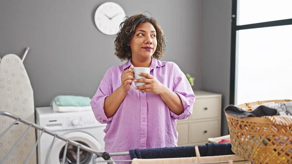 Young Beautiful Latin Woman Drinking Coffee Standing Clothesline Laundry Room — Stock Photo, Image