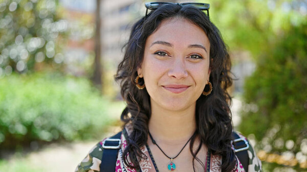 Young beautiful hispanic woman smiling confident standing at park