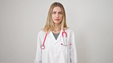 Sarışın kadın doktor ciddi bir ifadeyle, izole edilmiş beyaz arka planda parmağıyla hayır diyor.