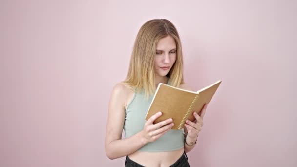 Young Blonde Woman Reading Book Doing Thumb Gesture Smiling Isolated — Stock Video
