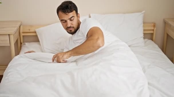 Young Hispanic Man Waking Sitting Bed Bedroom — ストック動画