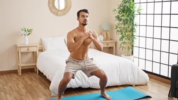 Young Hispanic Man Training Legs Exercise Bedroom — Stock Video