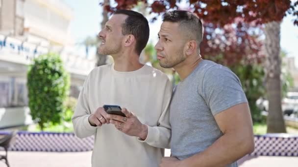 Двое Мужчин Ищут Место Назначения Смартфоне Парке — стоковое видео
