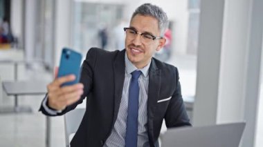 Young hispanic man business worker having video call at office
