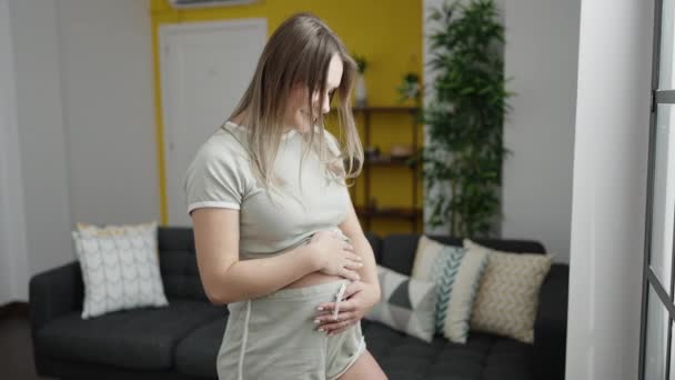 Young Pregnant Woman Smiling Confident Touching Belly Home — Video