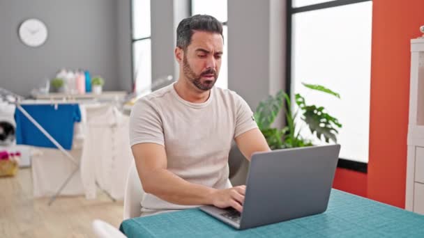 Young Hispanic Man Using Laptop Sneezing Dinning Room — Stock Video