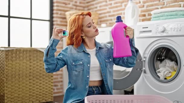 Çamaşır Odasında Çamaşır Deterjanı Seçen Genç Kızıl Saçlı Kadın — Stok video