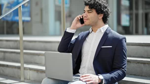 Young Latin Man Business Worker Using Laptop Talking Smartphone Street — Stock Video