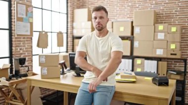 Young man ecommerce business worker standing with arms crossed gesture at office