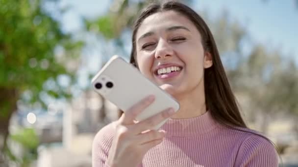 Νεαρή Όμορφη Ισπανόφωνη Γυναίκα Στέλνει Φωνητικό Μήνυμα Smartphone Στο Πάρκο — Αρχείο Βίντεο