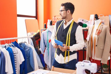 Atölyede dokunmatik ped kullanan İspanyol bir terzi.