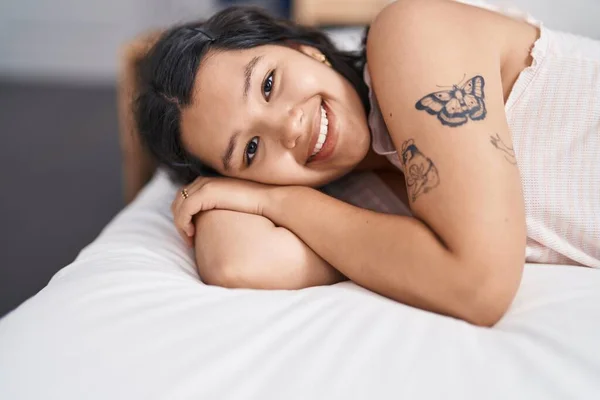 stock image Young woman smiling confident lying on bed at bedroom