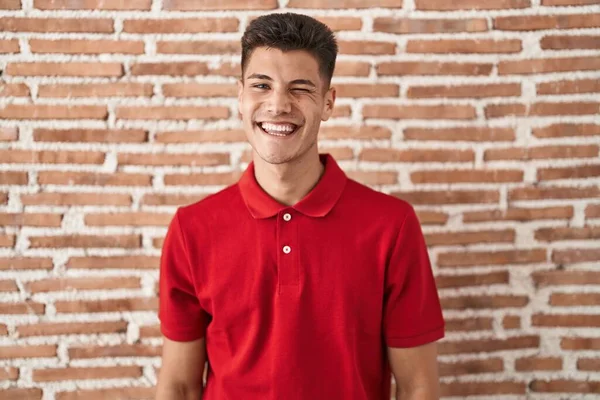 Fiatal Spanyol Férfi Áll Tégla Fal Kacsintás Kamerába Szexi Kifejezés — Stock Fotó