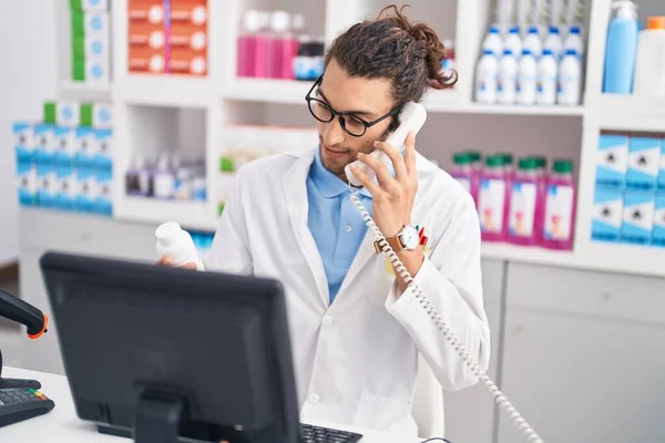 Young Hispanic Man Pharmacist Talking Telephone Holding Pills Bottle Pharmacy — Zdjęcie stockowe