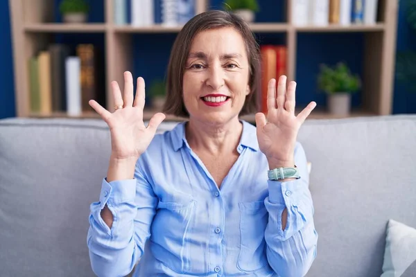 Middle Age Hispanic Woman Sitting Sofa Home Showing Pointing Fingers — Stock Photo, Image