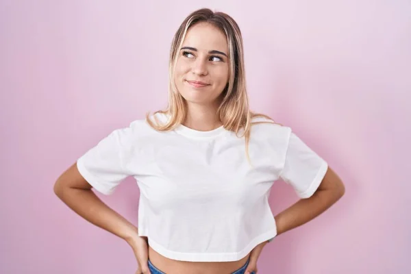 Jonge Blonde Vrouw Staan Roze Achtergrond Glimlachen Kijken Naar Zijkant — Stockfoto