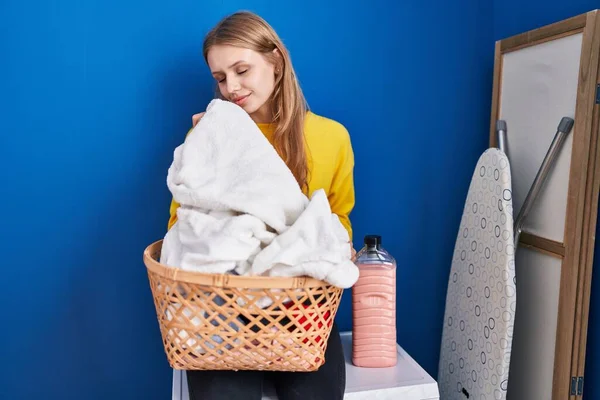 Young Blonde Woman Smelling Clean Towel Laundry Room — Stockfoto