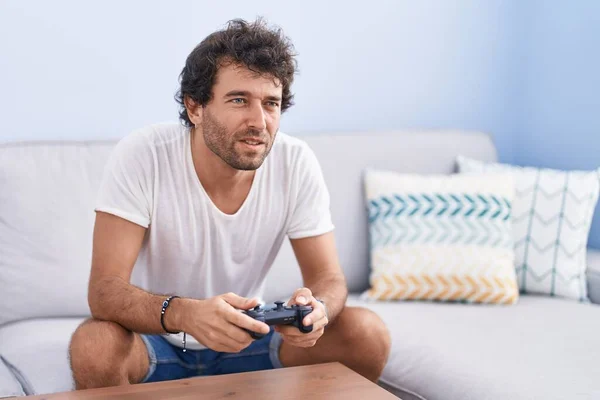 Young Hispanic Man Playing Video Game Sitting Sofa Home — Fotografia de Stock