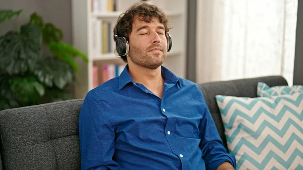 Young Hispanic Man Listening Music Relaxed Sofa Home — Stock Photo, Image