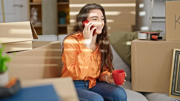 Young Beautiful Hispanic Woman Talking Smartphone Drinking Coffee New Home — 图库照片