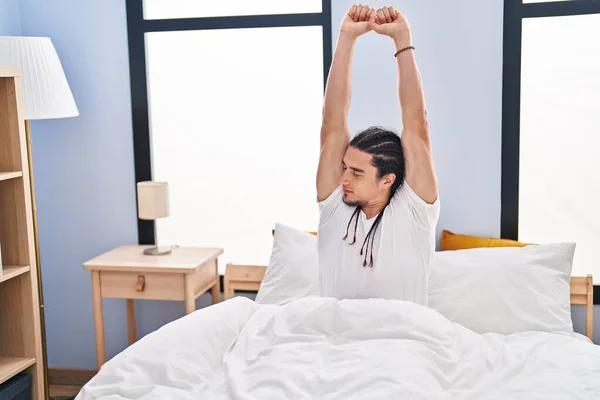 Young Man Stretching Arms Sitting Bed Bedroom — Stockfoto