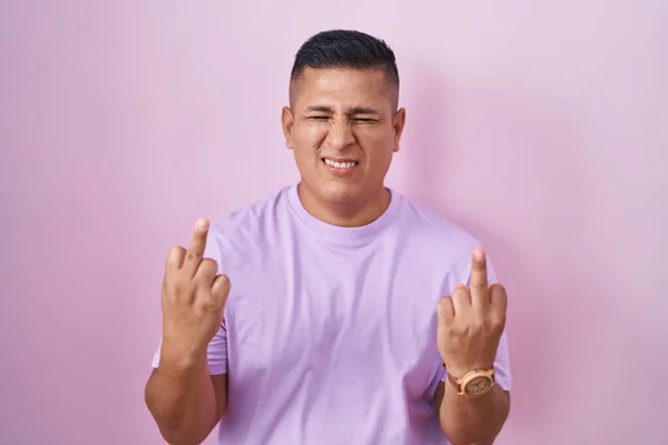 Young Hispanic Man Standing Pink Background Showing Middle Finger Doing — Zdjęcie stockowe