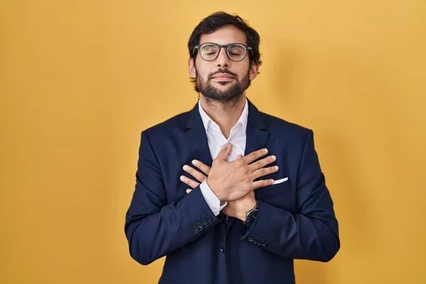 Handsome Latin Man Standing Yellow Background Smiling Hands Chest Closed — Stock Photo, Image