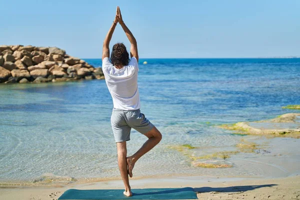 Young Hispanic Man Doing Yoga Exercise Standing Beach — 图库照片