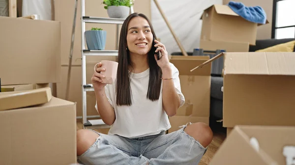 Young Beautiful Hispanic Woman Talking Smartphone Drinking Coffee New Home — Stok fotoğraf