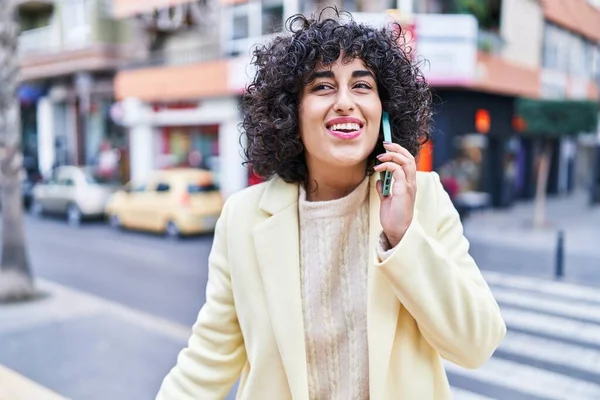 stock image Young middle east woman excutive smiling confident talking on the smartphone at street