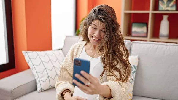 Jonge Zwangere Vrouw Met Smartphone Aanraken Buik Thuis — Stockfoto