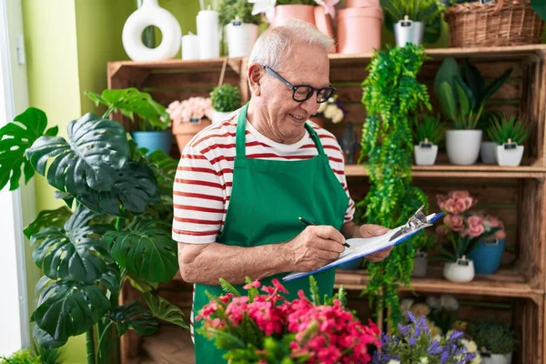 Middle Age Grey Haired Man Florist Smiling Confident Writing Document — ストック写真