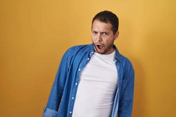 Hispanic Man Standing Yellow Background Shock Face Looking Skeptical Sarcastic — Stock Photo, Image