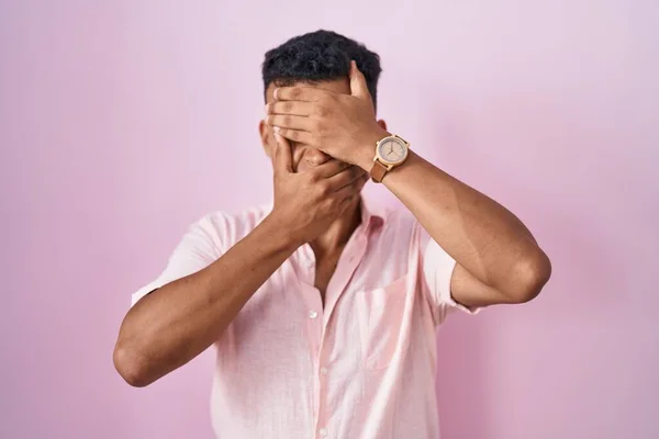 Young Hispanic Man Standing Pink Background Covering Eyes Mouth Hands — Stok fotoğraf