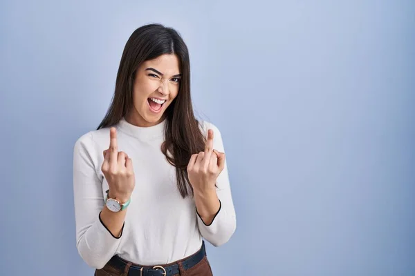 Young Brunette Woman Standing Blue Background Showing Middle Finger Doing — стоковое фото