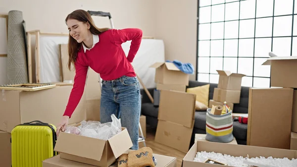 Young Hispanic Woman Suffering Backache Holding Package New Home — Stock Photo, Image