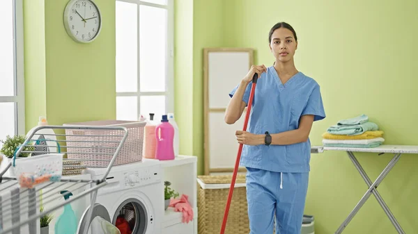 African American Woman Professional Cleaner Standing Serious Face Laundry Room — Stock Photo, Image